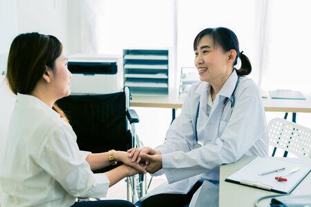 Hand of doctor reassuring her female patientの写真素材