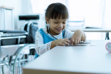 Asian little girl visiting a doctor. Medicine and children's therapy conceptの写真素材