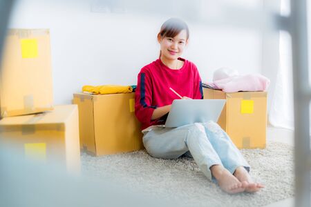 Asian young owner business woman working online shopping at homeの写真素材