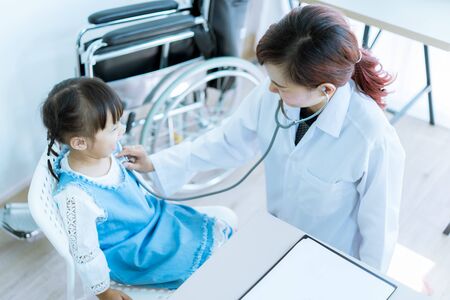 Asian cute girl visiting a doctorの写真素材