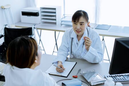 Female doctor consulting patient. Asian peopleの写真素材