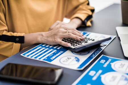 Business women reviewing data in financial charts and graphs. Accounting