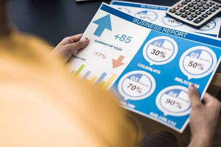 Business women reviewing data in financial charts and graphs. Accounting