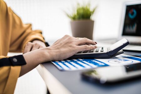 Business women reviewing data in financial charts and graphs. Accounting