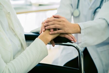 Hand of doctor reassuring her female patient