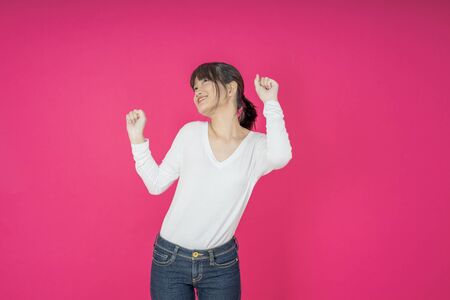 I won. Winning success happy woman celebrating being a winner. Dynamic image of caucasian female model on pink studio background. Victory, delight concept. Human facial emotions concept. Trendy colorsの写真素材