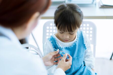 Asian cute girl visiting a doctorの写真素材