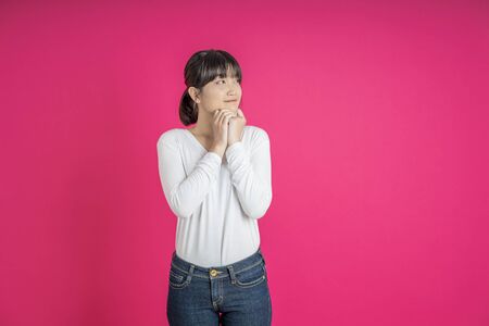 Young asian woman smiling.  Female half-length portrait. Human emotions, facial expression concept.の写真素材