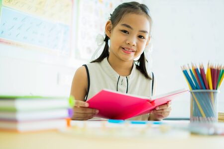 Asian cute little child girl drawing at homeの写真素材