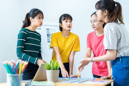 Asian female Designers Having Brainstorming Meeting In Officeの写真素材