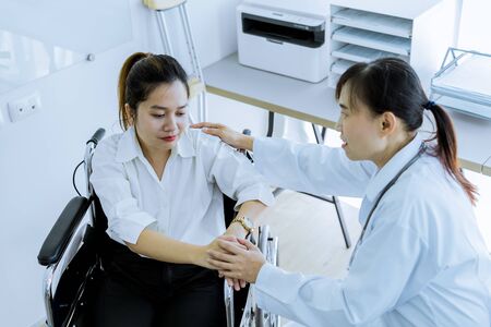 Hand of doctor reassuring her female patientの写真素材