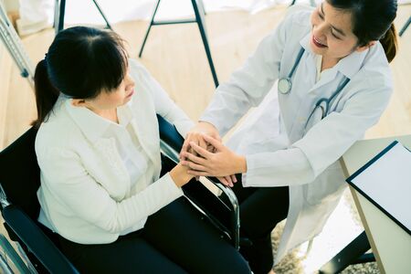 Hand of doctor reassuring her female patientの写真素材