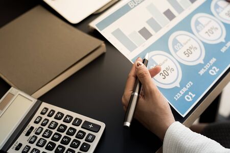 Business women reviewing data in financial statement. Accountingの写真素材