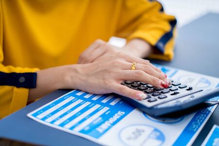 Business women reviewing data in financial charts and graphs. Accountingの写真素材