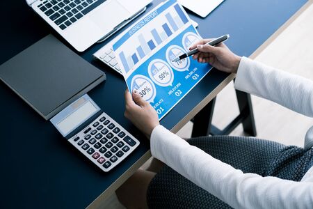 Business women reviewing data in financial statement. Accountingの写真素材