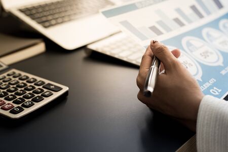 Business women reviewing data in financial statement. Accountingの写真素材