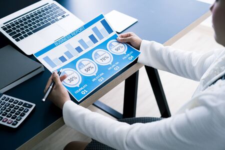 Business women reviewing data in financial statement. Accountingの写真素材
