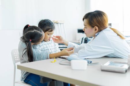 Asian cute girl visiting a doctor. Medicine and children's therapy conceptの写真素材