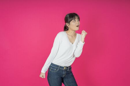I won. Winning success happy woman celebrating being a winner. Dynamic image of caucasian female model on pink studio background. Victory, delight concept. Human facial emotions concept. Trendy colorsの写真素材