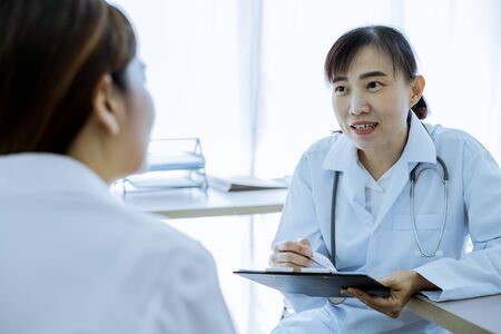 Female doctor consulting patient. Asian peopleの写真素材