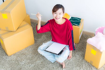 Asian young owner business woman working online shopping at homeの写真素材