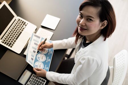 Business women reviewing data in financial statement. Accountingの写真素材