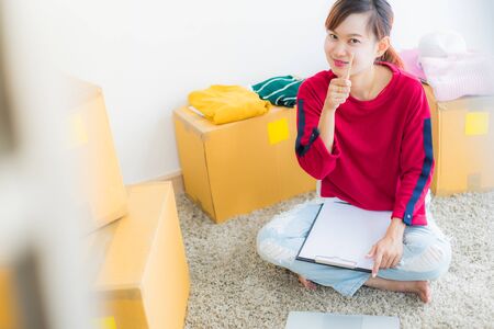 Asian young owner business woman working online shopping at homeの写真素材