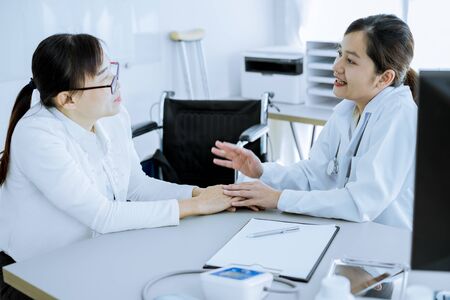 Hand of doctor reassuring her female patientの写真素材