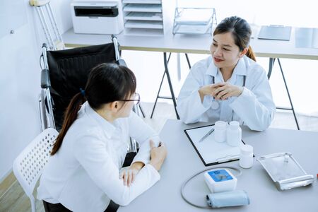 Female doctor consulting patient. Asian peopleの写真素材