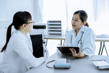 Female doctor consulting patient. Asian peopleの写真素材