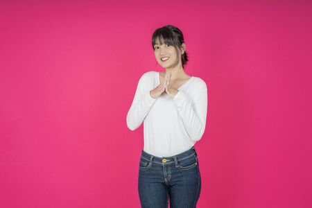 Do not miss. Young asian woman shouting. Shout. Crying emotional  woman screaming on pink studio background. Female half-length portrait. Human emotions, facial expression concept. Trendyの写真素材
