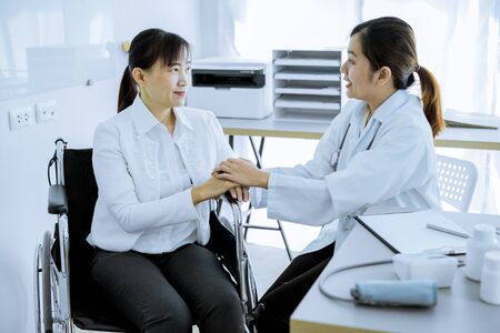 Hand of doctor reassuring her female patientの写真素材