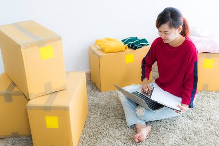 Asian young owner business woman working online shopping at homeの写真素材