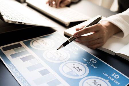 Business women reviewing data in financial statement. Accountingの写真素材