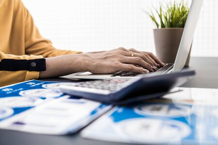 Business women reviewing data in financial charts and graphs. Accountingの写真素材