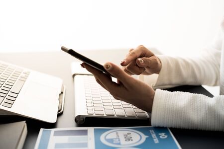 Business woman using mobile phone in officeの写真素材