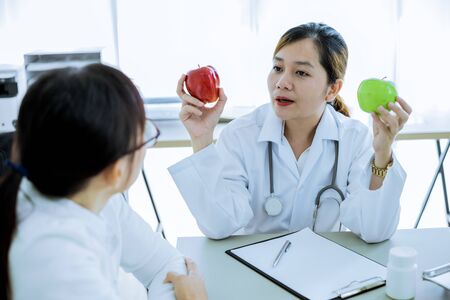 Female doctor consulting patient. Asian peopleの写真素材