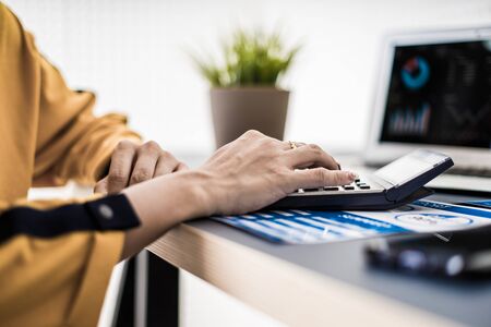 Business women reviewing data in financial charts and graphs. Accountingの写真素材