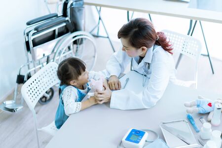 Asian cute girl visiting a doctorの写真素材