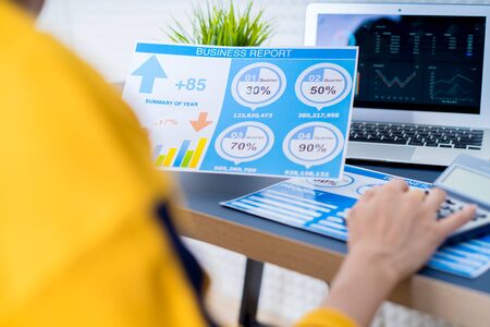 Business women reviewing data in financial charts and graphs. Accountingの写真素材