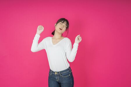 I won. Winning success happy woman celebrating being a winner. Dynamic image of caucasian female model on pink studio background. Victory, delight concept. Human facial emotions concept. Trendy colorsの写真素材