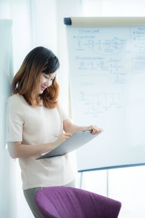 Portrait of young beautiful asian business woman in the office.の写真素材