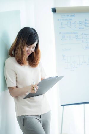 Portrait of young beautiful asian business woman in the office.の写真素材