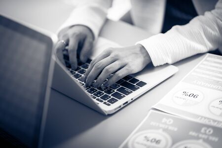 Asian business woman reviewing data in financial charts and graphs. Accountingの写真素材