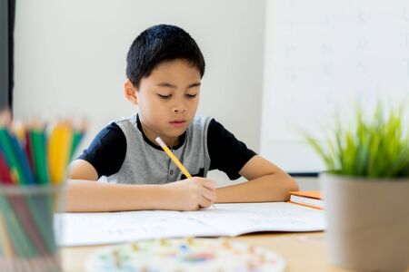 Asian little boy drawing at home. Education conceptの写真素材