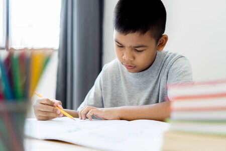 Asian little boy drawing at home. Education conceptの写真素材