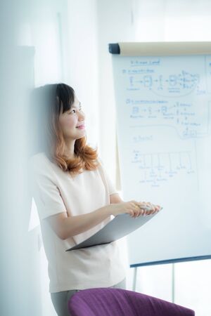 Portrait of young beautiful asian business woman in the office.の写真素材