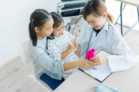 Asian cute girl visiting a doctor. Medicine and children's therapy conceptの写真素材