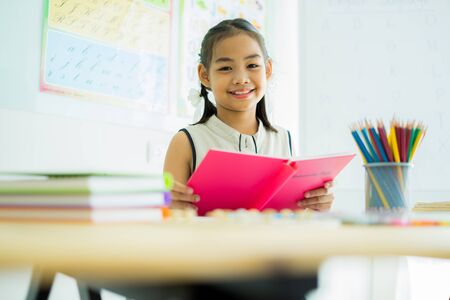 Asian cute little child girl drawing at homeの写真素材