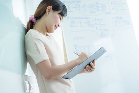 Portrait of young beautiful asian business woman in the office.の写真素材